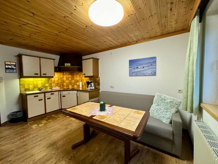 Kitchen and living area with dining table