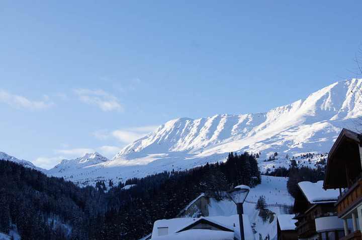 Village rooftops beneath the snow-covered ridge