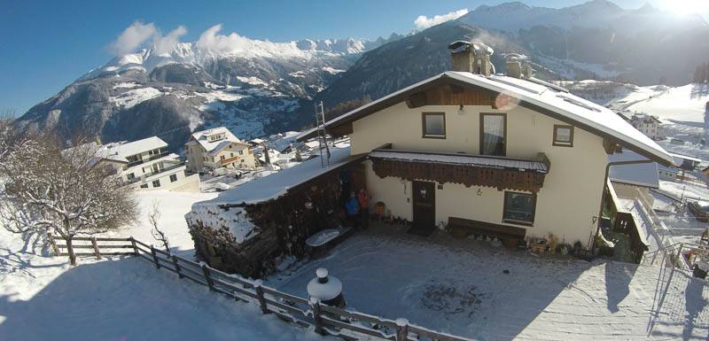 The Wolf family house in the snow beneath the Tyrolean mountains